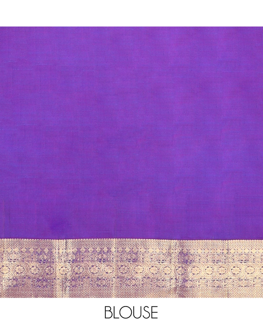 Violet Kanchipuram Silk Saree, Ornamented with Zari Buttas All Over Its Body, Highlighted by Zari Border of Thilakam, Mayil Kann, Poun, Jada Nagam, Dhavana Kodi, and Mayil Kann Designs, Pallu of Jaal Designs, and Paired with a Matching Blouse