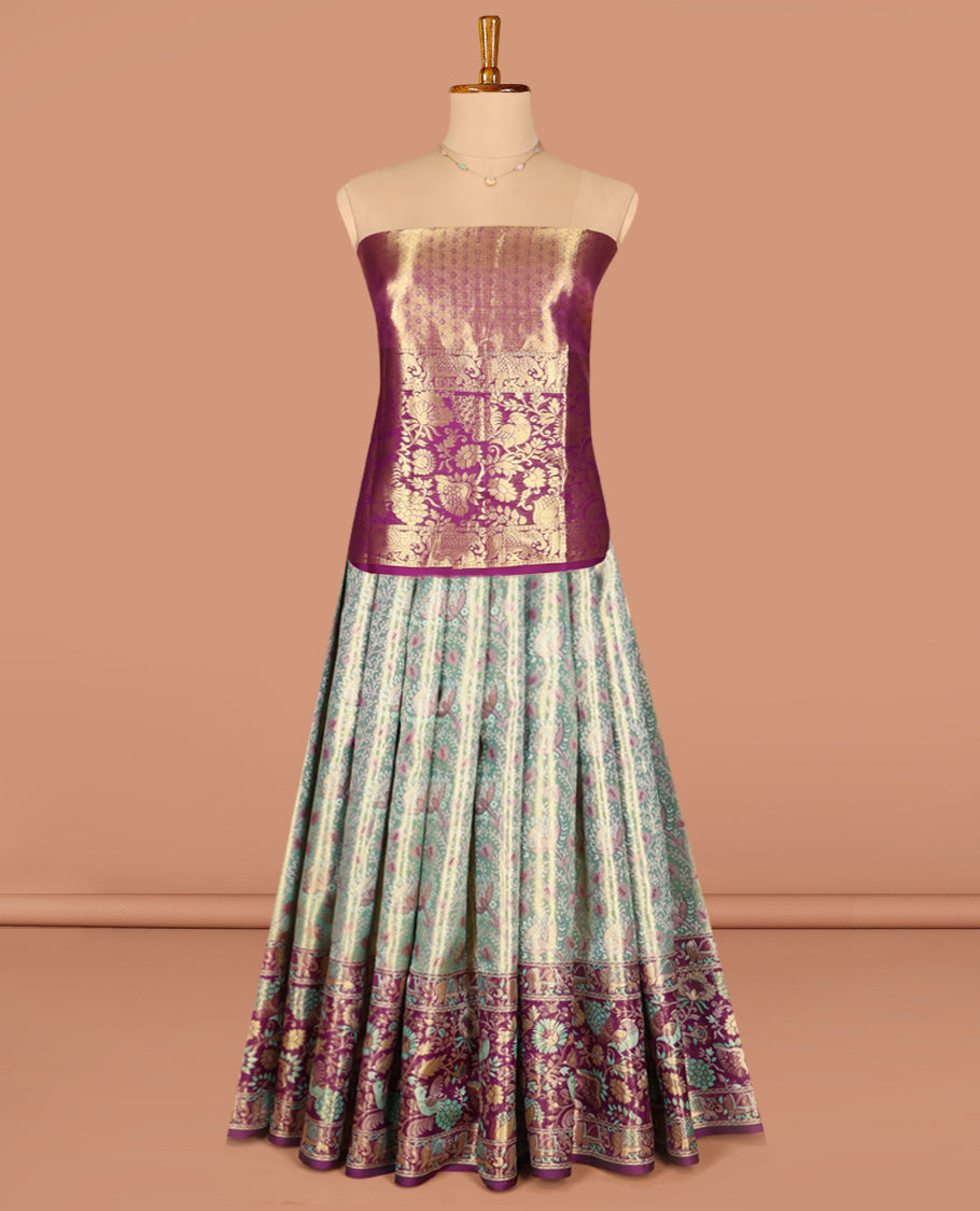 Green Pure Silk Half-Saree, Artfully Detailed with Floral Jacquard All Over Its Skirt, Complemented by a Contrast Border of Yaanai, Mayil, and Kodi Visiry Designs, Paired with a Contrast Blouse, and Comes with an Intricately Designed Dhavani
