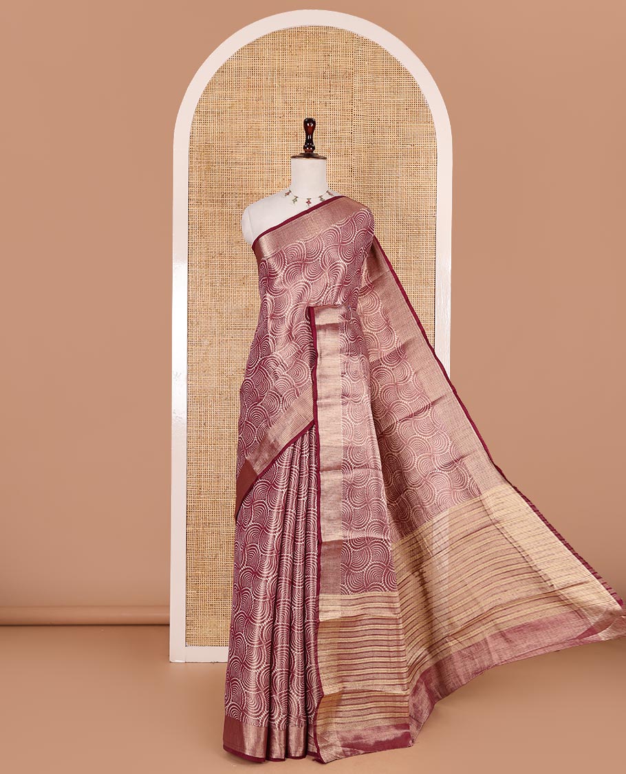 Wine scallop design tissue saree, zari striped border, striped pallu, and gleaming matching blouse