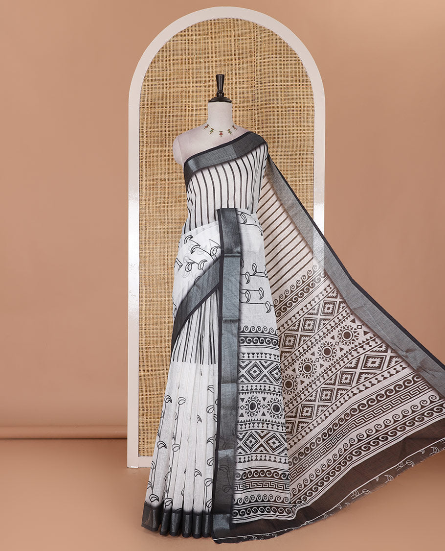 White and black combo printed linen cotton saree features stripes and leaf creeper design, zari border, geometric printed pallu, and contrast printed blouse