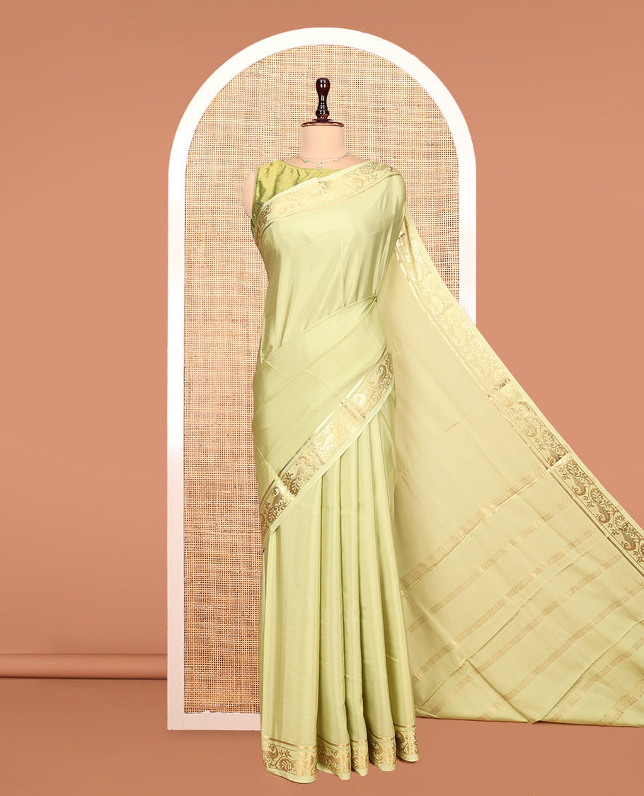 Green Plain Mysore Silk Saree, Highlighted by a Traditional Zari Border of Peacock Designs, Pallu Steeped with Zari Stripes, and Paired with a Matching Blouse