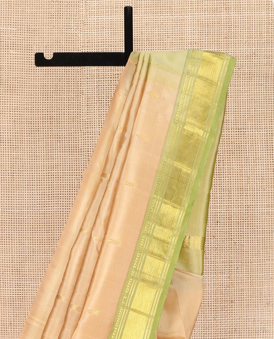 Sandal Kanchipuram Silk Saree, Subtly Sparkled with Thread Buttas on Its Body, Complemented by a Contrast One-Sided Border of Panner Sombu, Banaras, and Mayil Kann Designs, Pallu Features Zari Designs, and Comes Without a Blouse