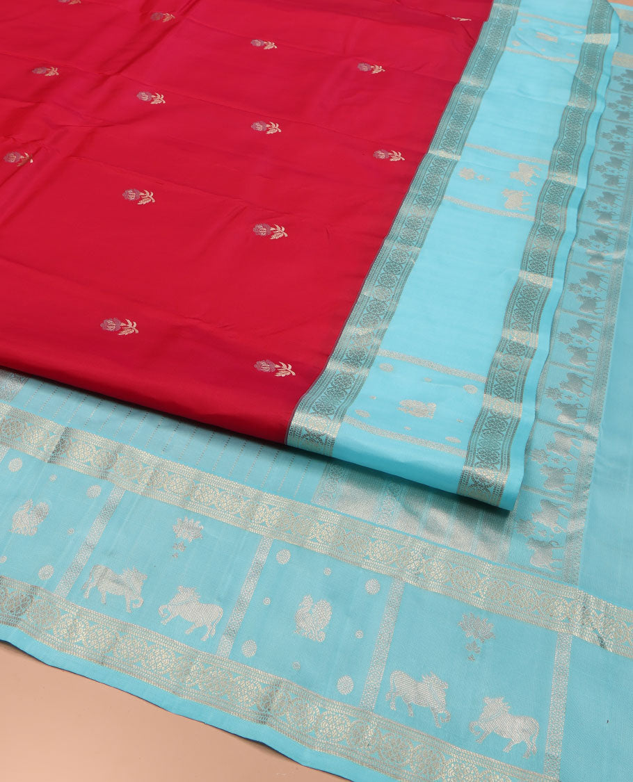 Red Vasundhara Silk Saree, Embellished with Floral Buttas on Its Body, Complemented by Contrast Border of Kodi Visiry, Annam, Pichwai Cow and Lotus Designs, Meticulously Crafted Pallu, and Paired with a Contrast Blouse