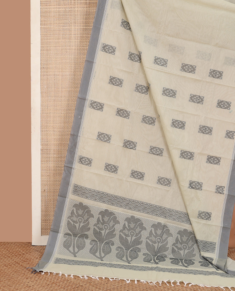 Beige buttas kanchi cotton saree, contrast plain border, and floral design pallu