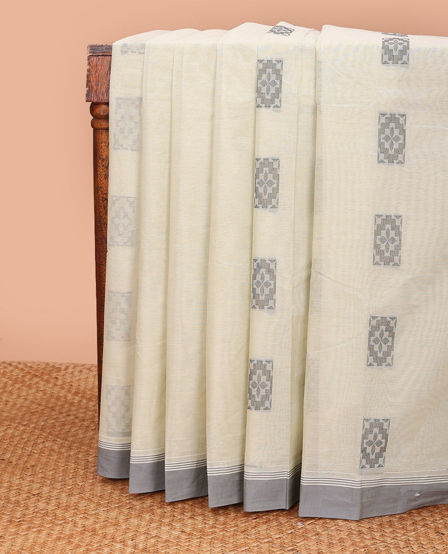 Beige buttas kanchi cotton saree, contrast plain border, and floral design pallu