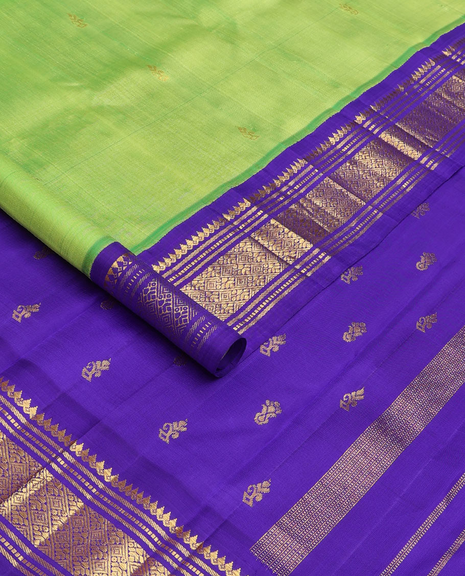 Green zari buttas Kanchipuram silk saree, contrast one-sided korvai zari border of thilakam mokku, banaras, muthu, and jaal, and zari design pallu