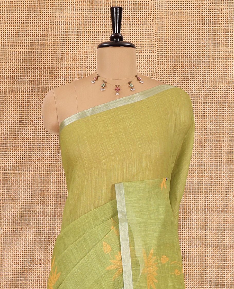 Green Pichwai lotus printed linen cotton saree, piping zari border, colorful tasselled lotus printed pallu, and a contrast lotus printed blouse