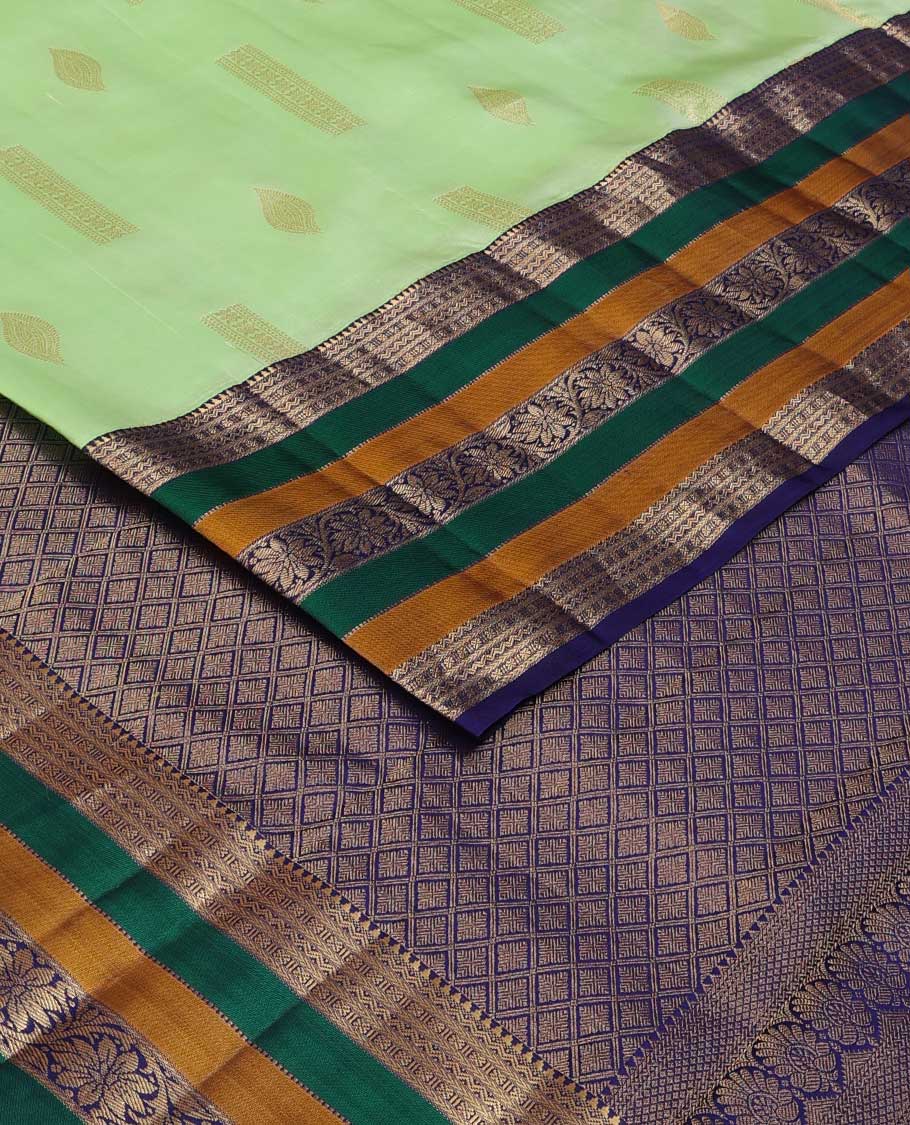 Green zari buttas silk saree, contrast border of rekku, neli, lavangam, Muthu, and rudraksham designs, and jaal pallu