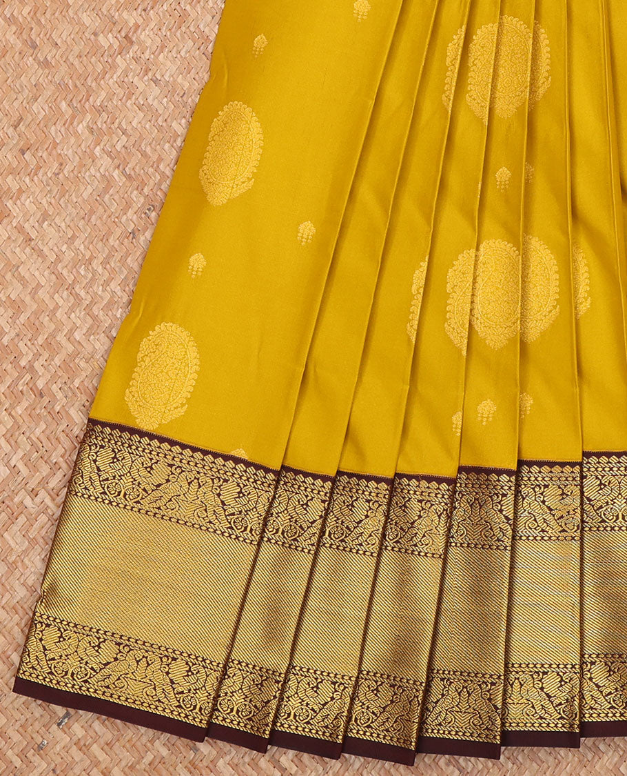 Yellow Budget Silk Saree, Subtly Sparkled with Paisley Buttas All Over Its Body, Complemented by a Contrast Traditional Zari Design Border of Peacock Designs, Opulently Embellished Pallu, and Paired with a Contrast Blouse