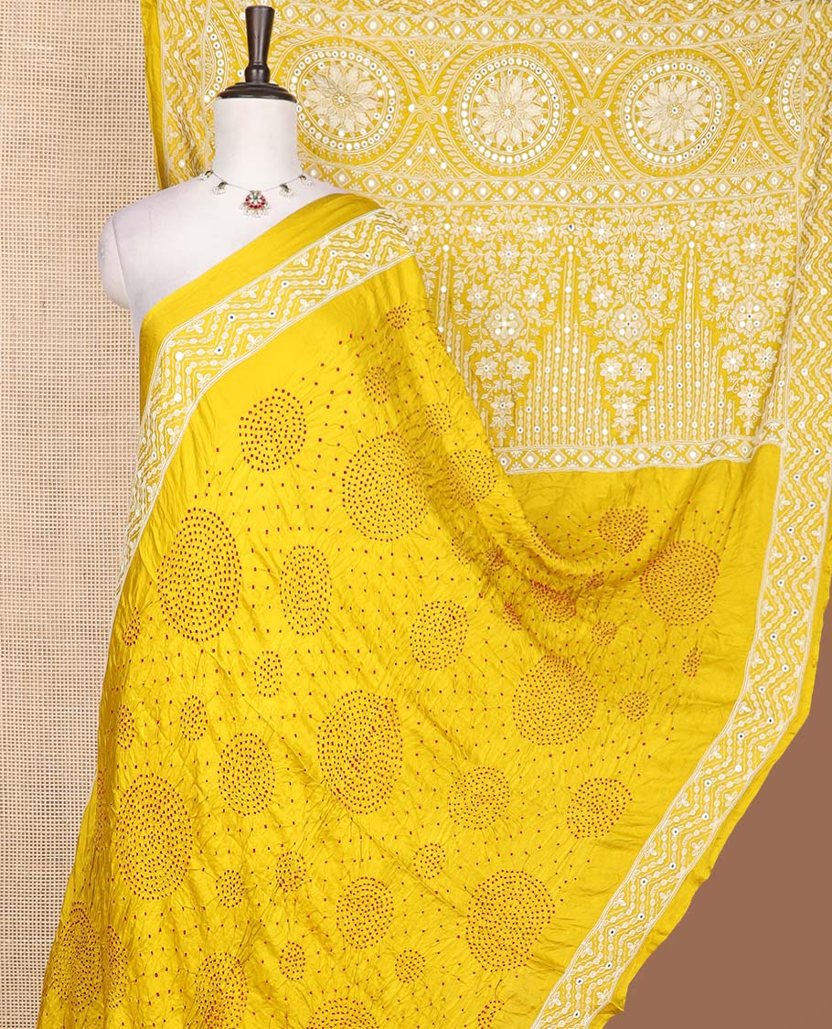 Yellow bandhani dotted bandhani silk saree, thread and mirror work border, and pallu of thread and mirror work
