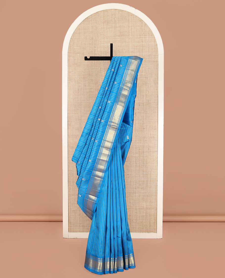 Blue Kanchipuram Silk Saree, Beautified with Zari Buttas and Stripes on Its Body, Highlighted by a Zari One-Sided Border of Panner Sombu, Banaras, and Jaal Designs, Pallu Features Zari Designs, and Comes Without a Blouse