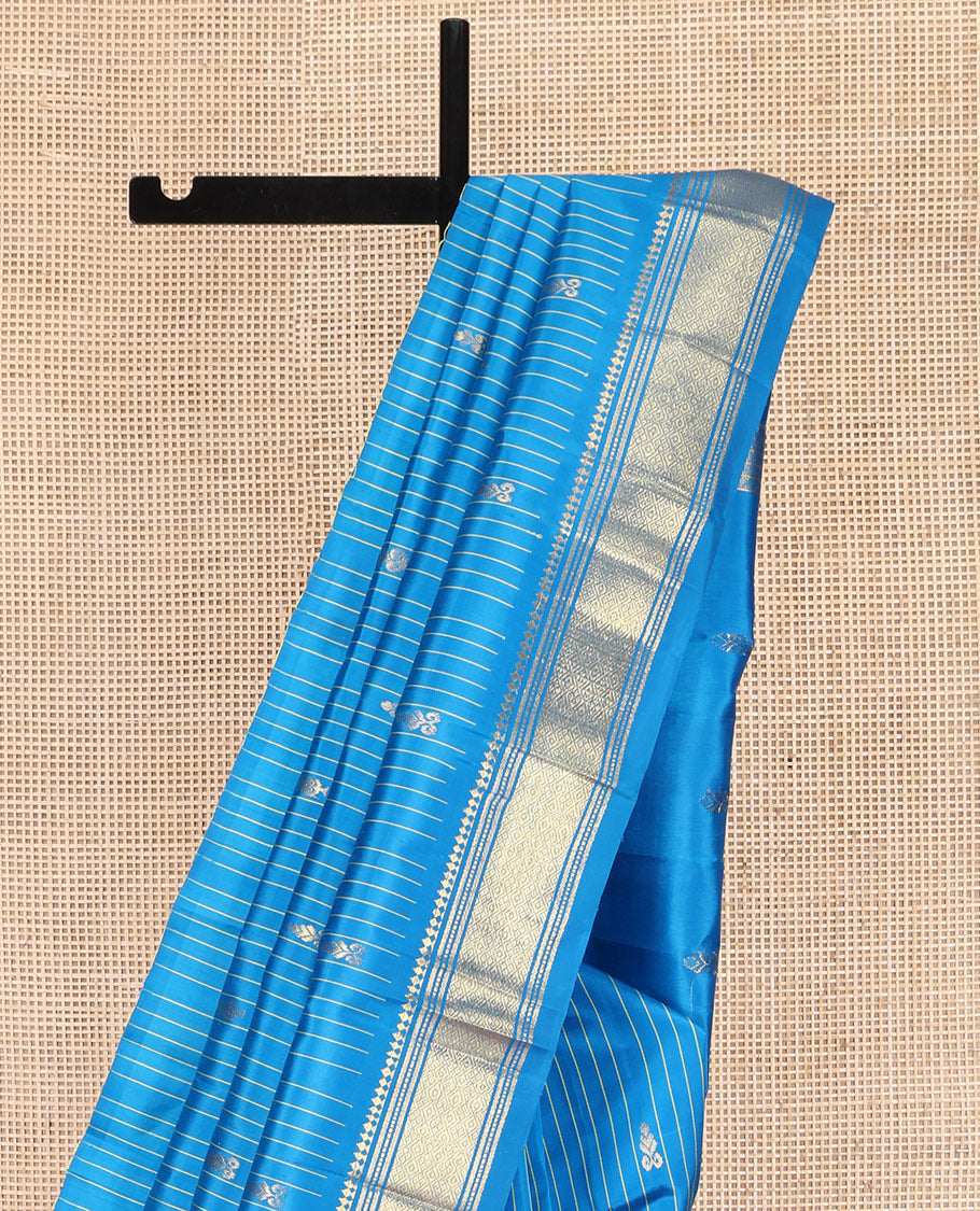 Blue Kanchipuram Silk Saree, Beautified with Zari Buttas and Stripes on Its Body, Highlighted by a Zari One-Sided Border of Panner Sombu, Banaras, and Jaal Designs, Pallu Features Zari Designs, and Comes Without a Blouse
