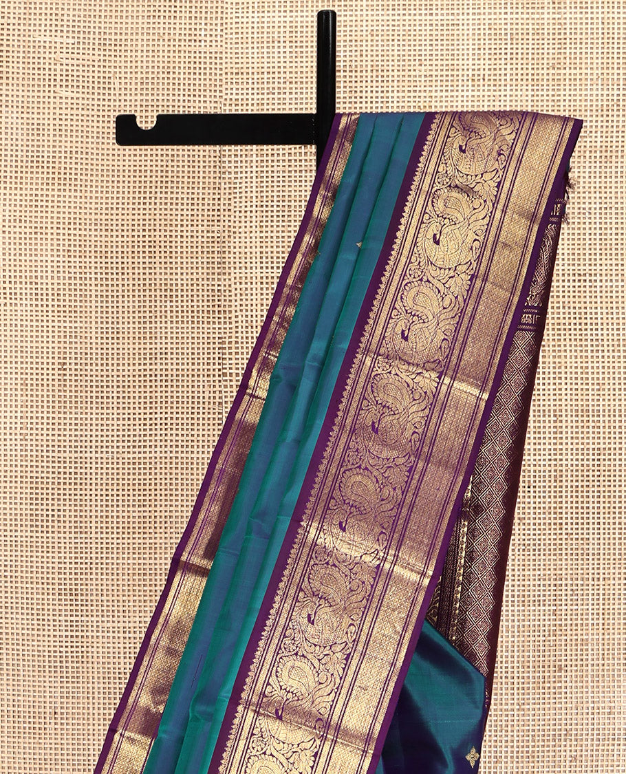 Blue Kanchipuram Silk Saree, Features Zari Buttas All Over Its Body, Complemented by a Contrast Border of Mayil Kann, Mayil, and Jaal Designs, Grand Jaal Pallu, and Paired with a Contrast Blouse