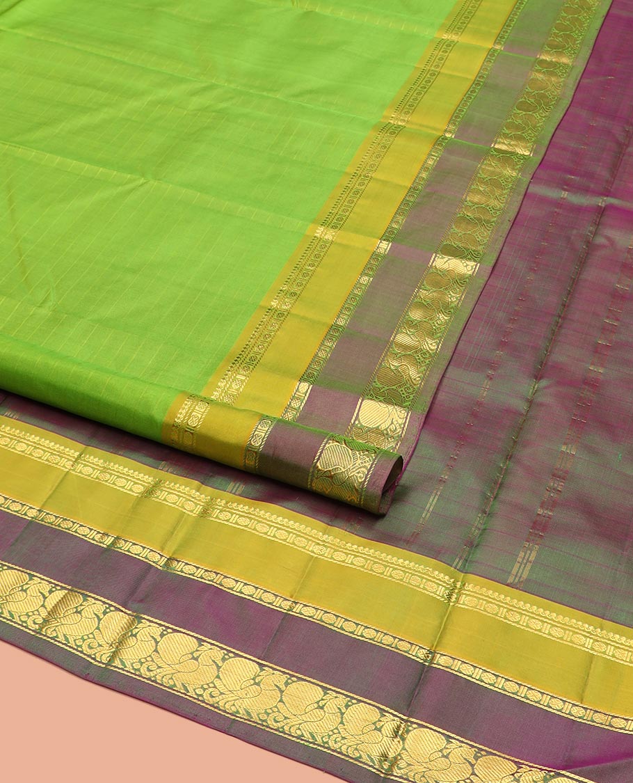 Green Kanchipuram Silk Saree Adorned with Vazhaipoo Stripes, Complemented by Contrast Rettai Pettu Border of Thilakam Mokku, Rudraksham, and Mayil Designs, Zari Woven Pallu, and Paired with a Contrast Blouse