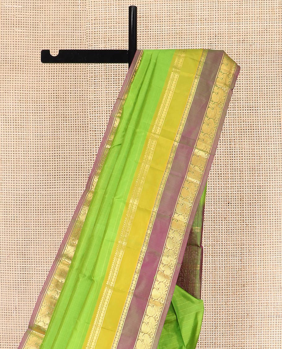 Green Kanchipuram Silk Saree Adorned with Vazhaipoo Stripes, Complemented by Contrast Rettai Pettu Border of Thilakam Mokku, Rudraksham, and Mayil Designs, Zari Woven Pallu, and Paired with a Contrast Blouse