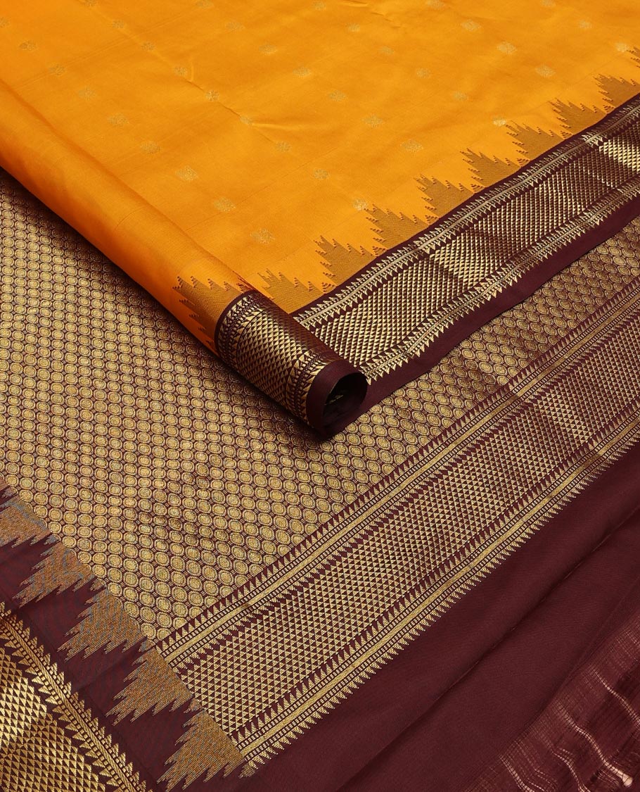 Orange zari buttas silk saree, contrast border of thazampoo rekku,ara bogudi,muthu & ara maadam & circular motifs pallu