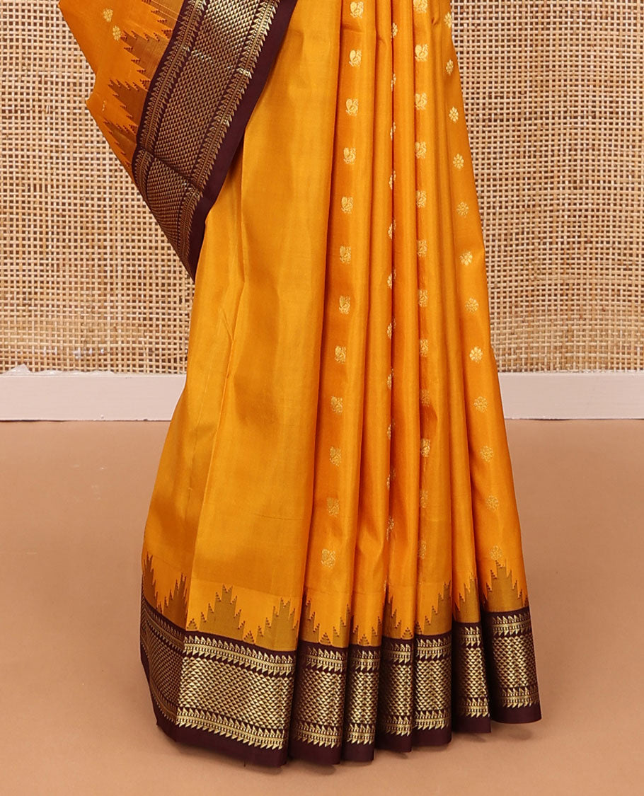 Orange zari buttas silk saree, contrast border of thazampoo rekku,ara bogudi,muthu & ara maadam & circular motifs pallu
