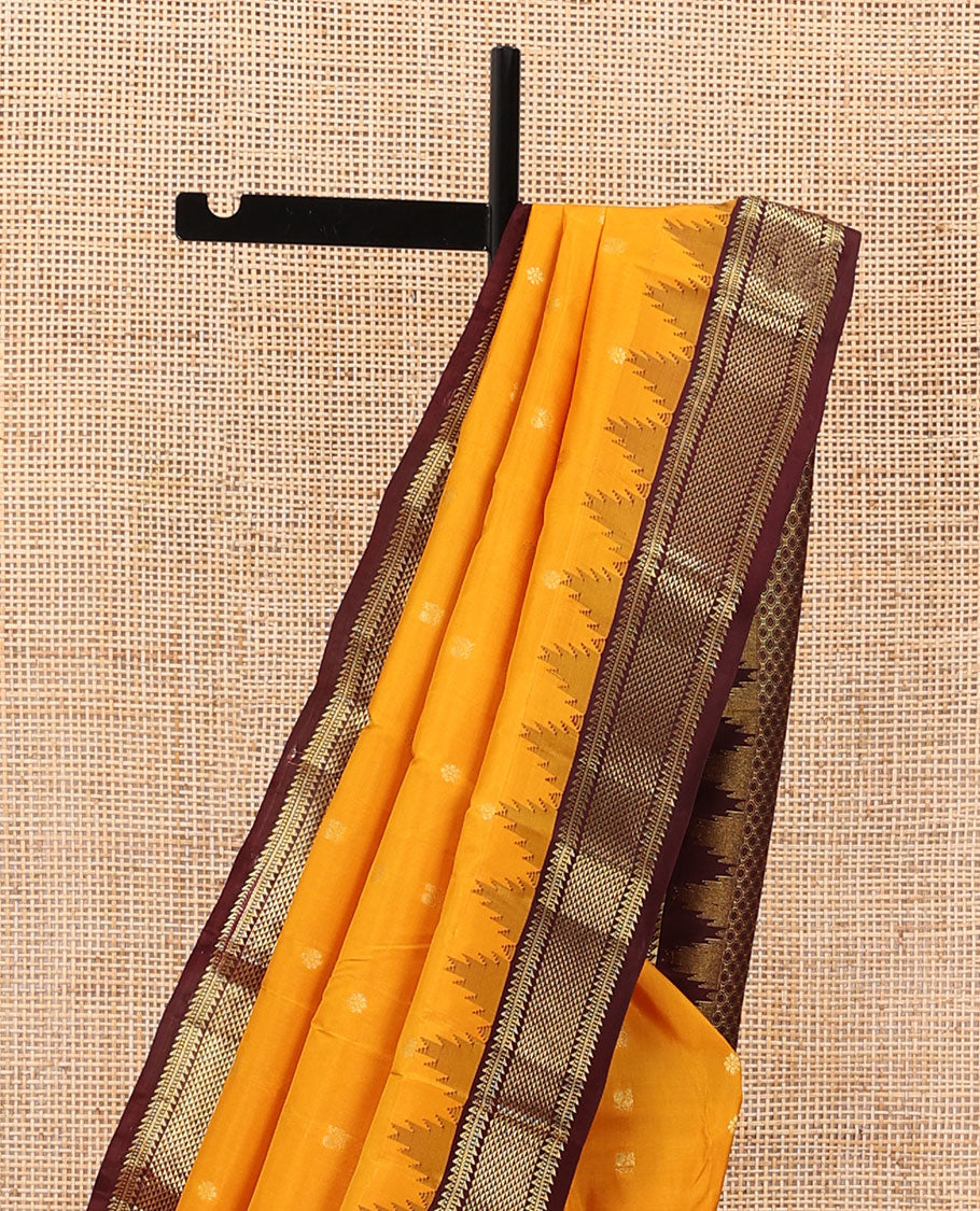 Orange zari buttas silk saree, contrast border of thazampoo rekku,ara bogudi,muthu & ara maadam & circular motifs pallu