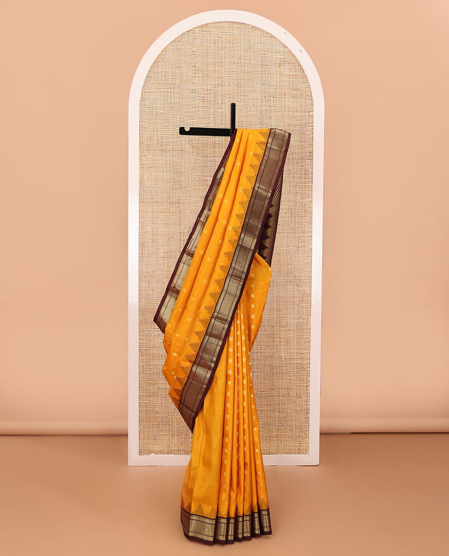 Orange zari buttas silk saree, contrast border of thazampoo rekku,ara bogudi,muthu & ara maadam & circular motifs pallu