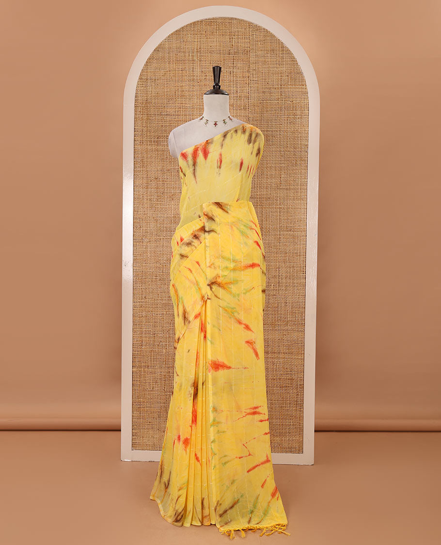 Borderless yellow shibori-style printed & sequins work marble chiffon saree, self-pallu with tassels & contrast embroidered blouse