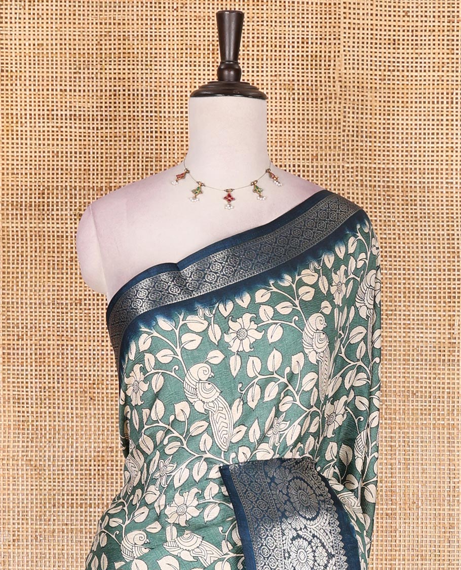 Green kalamkari floral vine and peacock printed dola silk saree, contrast traditional zari border, peacock printed pallu, and floral vine print blouse