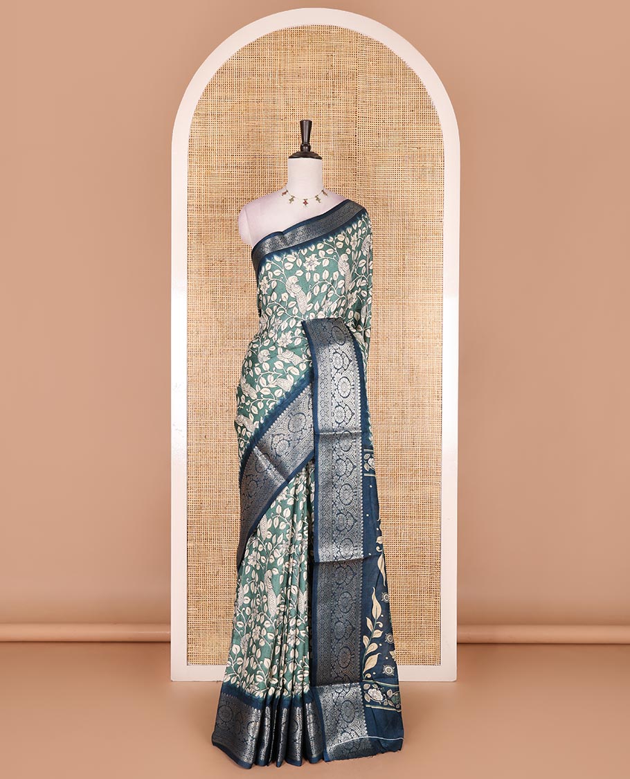 Green kalamkari floral vine and peacock printed dola silk saree, contrast traditional zari border, peacock printed pallu, and floral vine print blouse