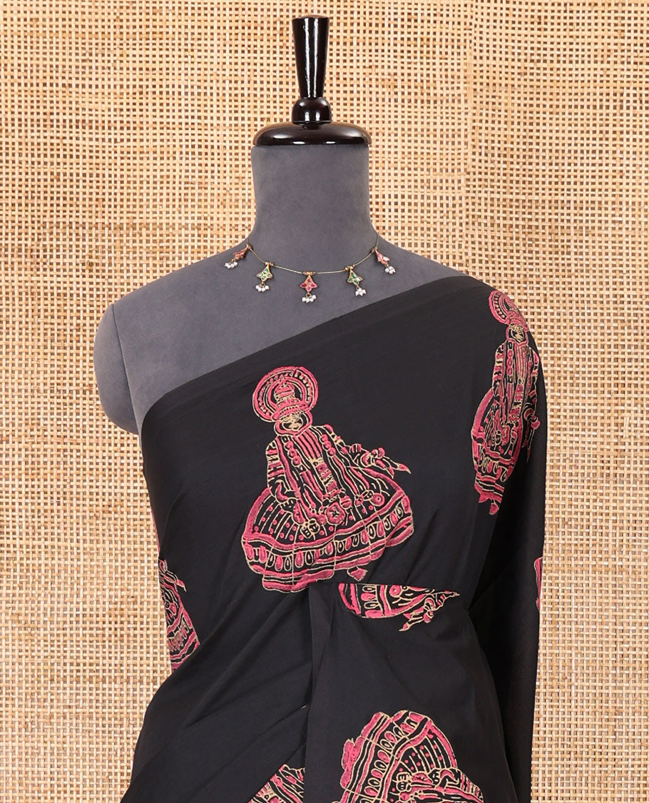Borderless black kolam and kathakali motifs printed South cotton saree with a matching blouse, and a contrast floral-peacock vine printed blouse