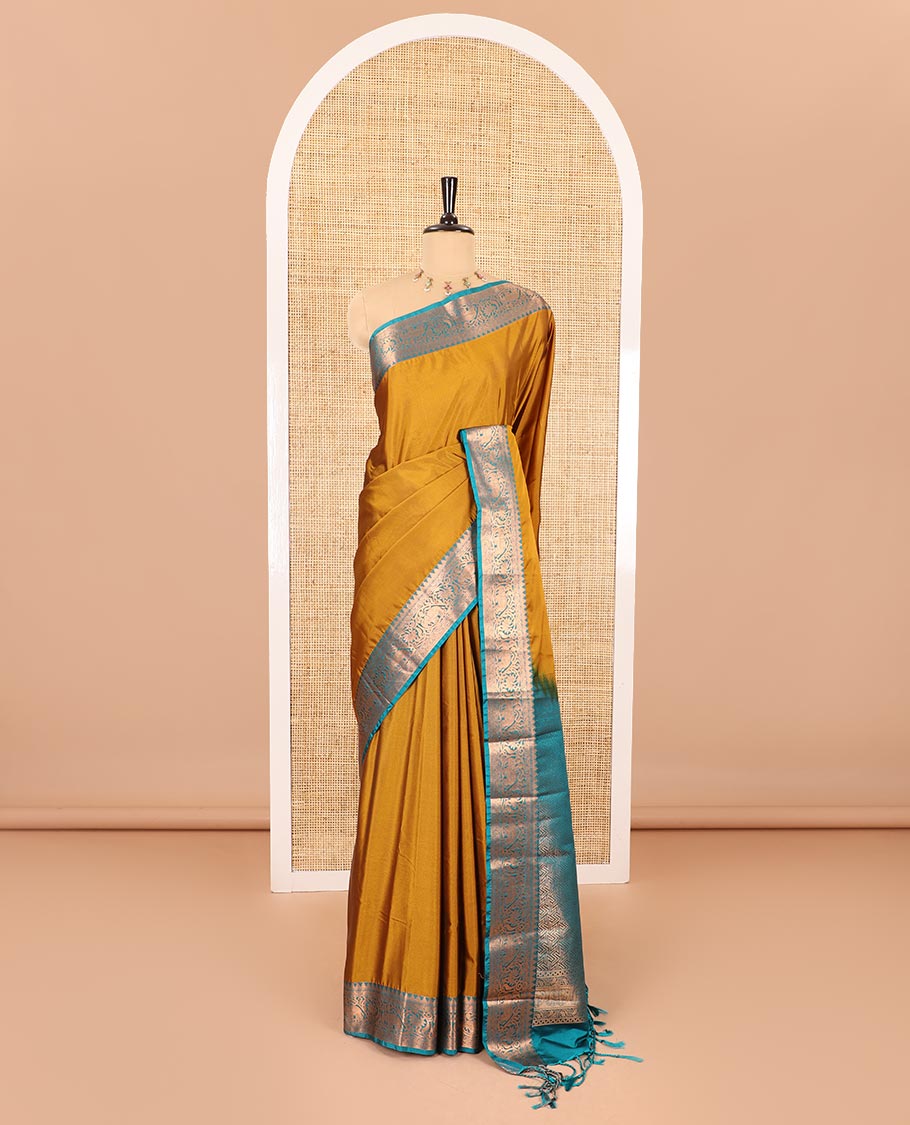 Gold plain luxury soft silk saree, contrast traditional temple zari border of elephant motifs, geometric zari pallu, and a contrast jacquard blouse