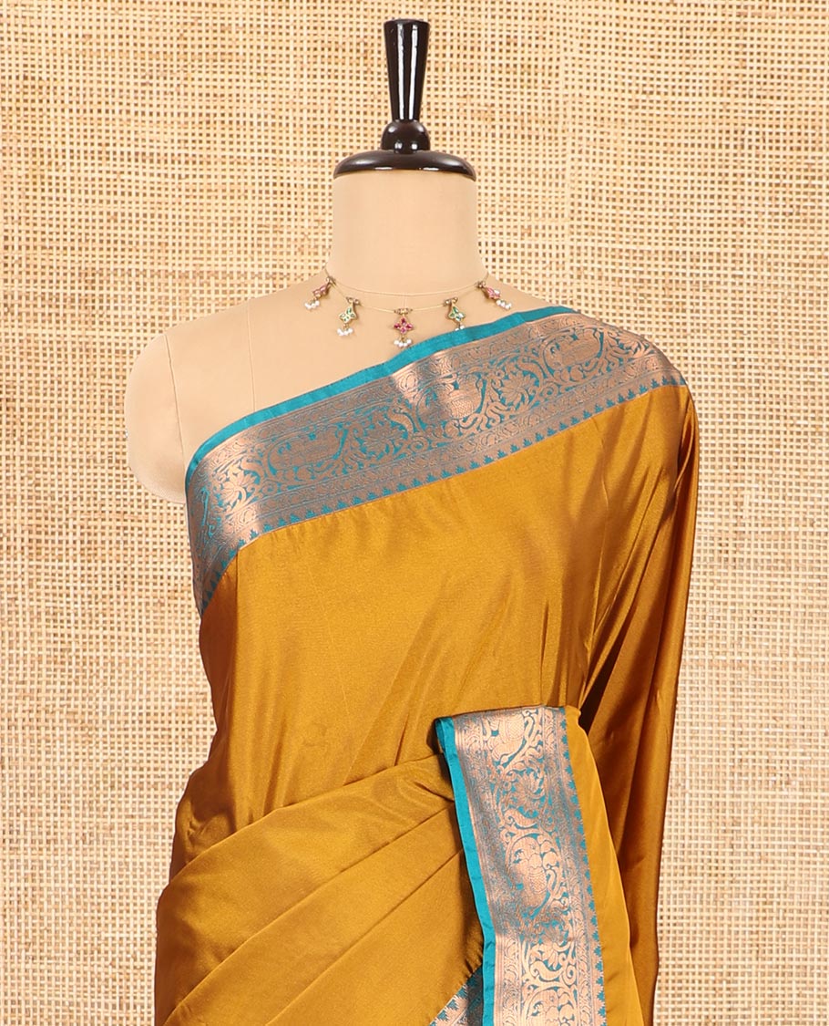 Gold plain luxury soft silk saree, contrast traditional temple zari border of elephant motifs, geometric zari pallu, and a contrast jacquard blouse