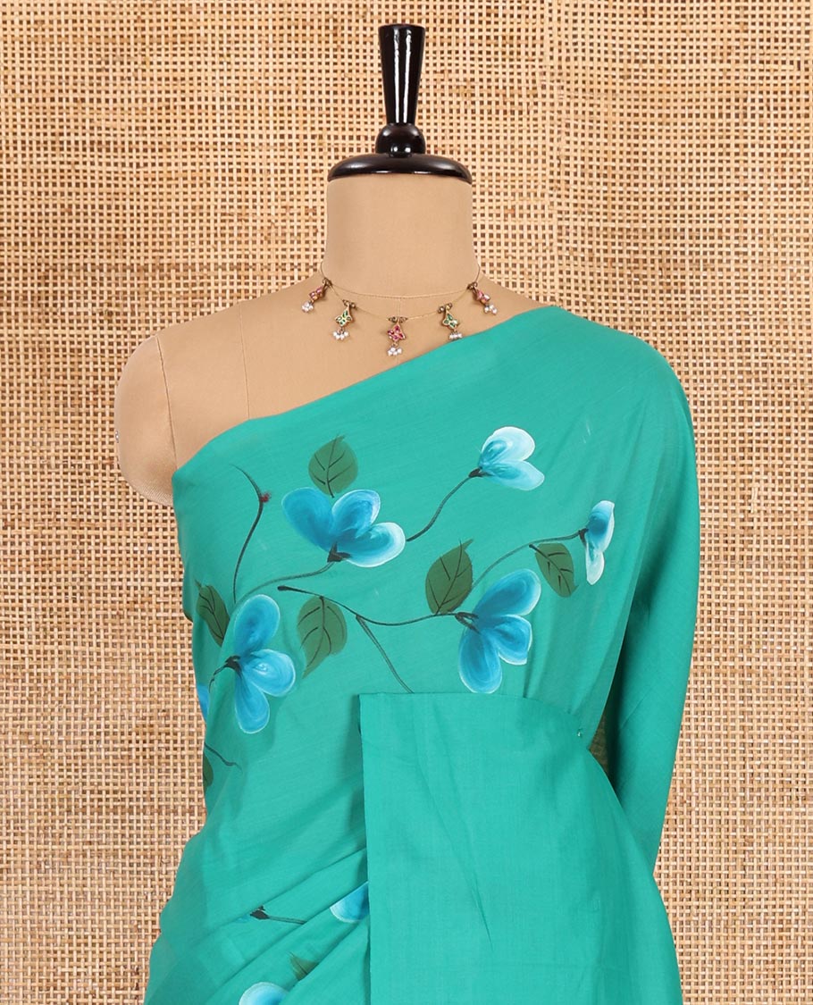 Borderless peacock green floral vine hand painting style placement printed South cotton saree and a matching floral printed blouse