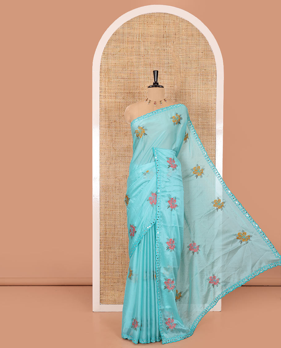 Blue floral motifs embroidered rangoli chiffon saree with mirror work border, embroidered pallu, and a contrast intricate scallop design embroidered blouse