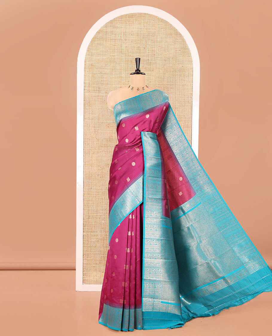 Pink Kanchi Silk Saree, Detailed with Peacock-Chakram Buttas All Over Its Body, Complemented by a Contrast Border of Floral Creeper Designs, an Intricately Designed Pallu, and Paired with a Matching Blouse