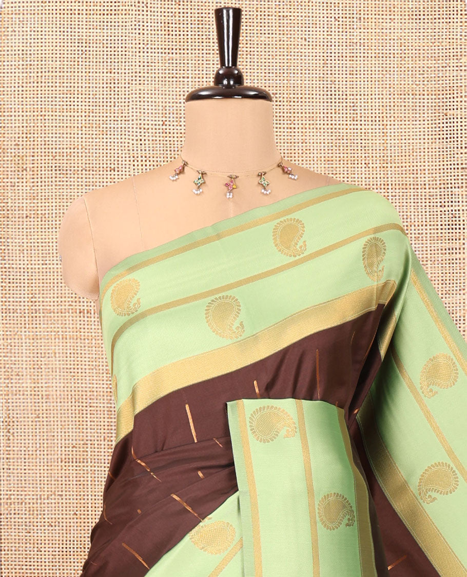 Brown and Green Kanchi Silk Saree, Ornamented with Zari Buttas All Over Its Body, Complemented by a Contrast Border of Paisleys, Zari-Striped Pallu, and Paired with a Contrast Jacquard Blouse