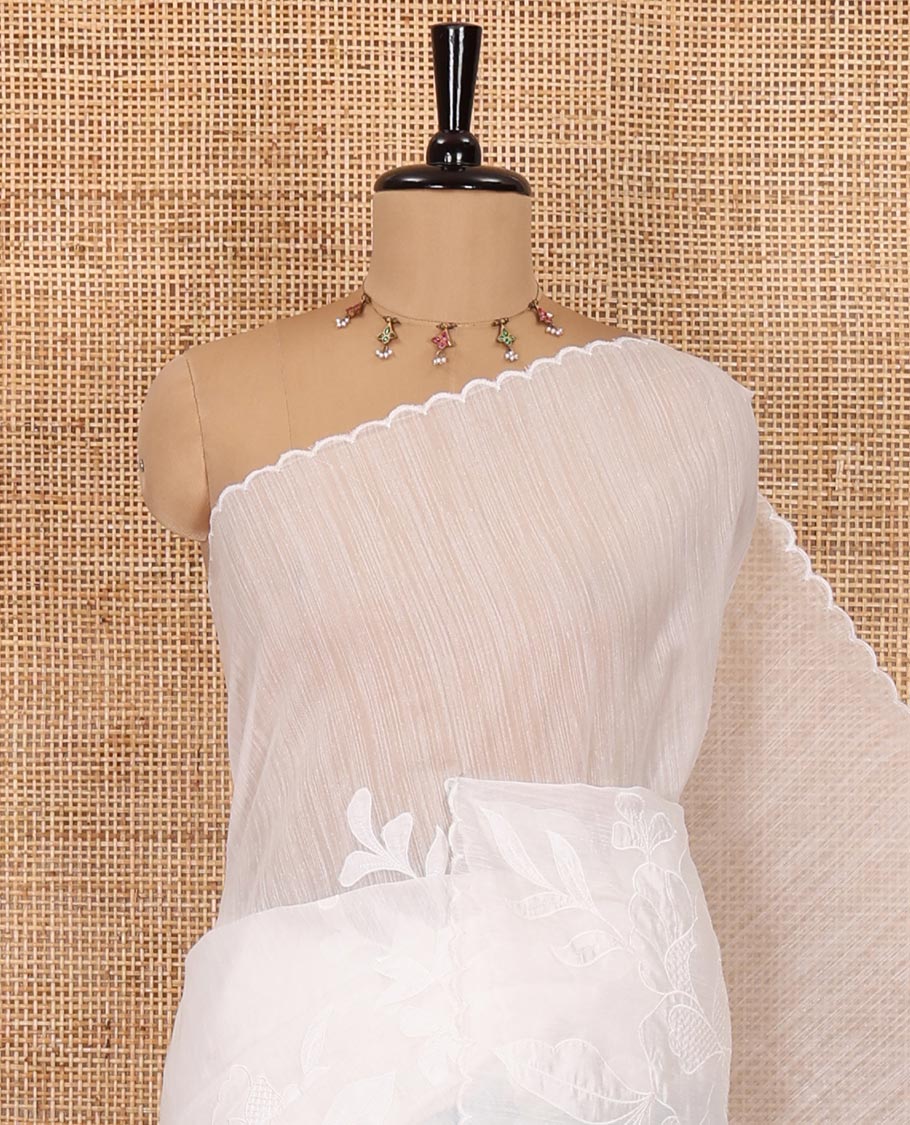 White floral motifs applique embroidered linen saree, scallop border, floral motifs embroidered pallu, and a plain blouse