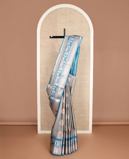 Grey zari designs soft silk saree, contrast zari border of human figurines, and pallu of intricate designs