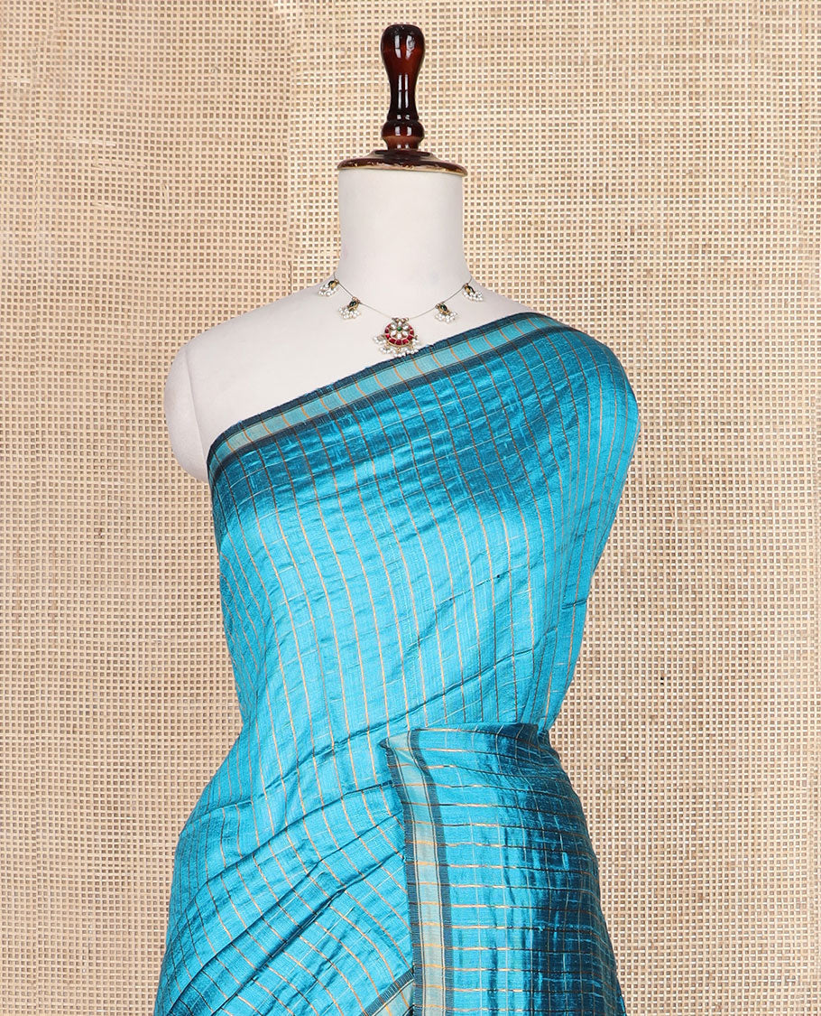 Blue checked tussar silk saree, zari border, and contrast striped pallu