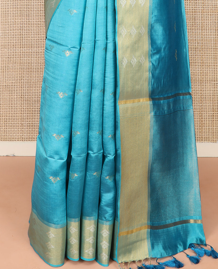 Blue Banana Pith Saree Elegantly Framed with Zari Buttas, Artfully Detailed Border with Zari Designs, Gleaming Zari Stripes Woven Pallu, and Paired with a Matching Plain Blouse