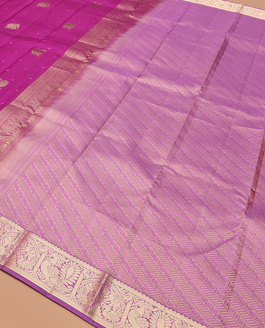 Rani pink mayil and yaanai buttas silk saree, contrast border of rekku, kathir, mayil, and yaanai designs, and pallu of geometric patterns