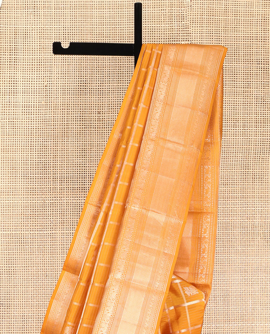 Yellow Vasundhara Silk Saree, Enriched with Zari Butta Enclosed Checked Design All Over Its Body, Highlighted by Zari Border of Thilakam Mokku, Muthu, Mayil, Yaanai, and Mayil Kann Designs, Grand Jaal Pallu, and Paired with a Matching Blouse