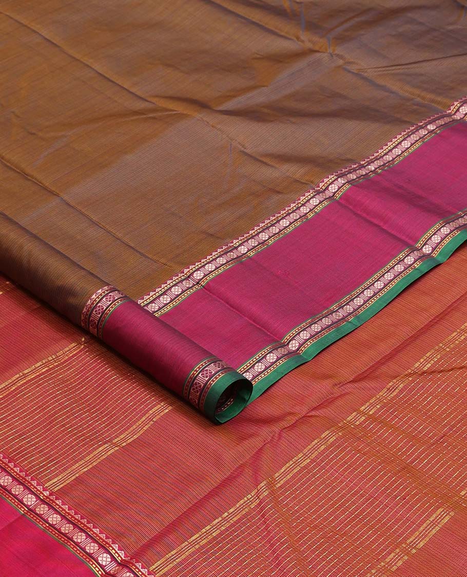 Brown plain Kanchipuram silk saree, contrast border of rekku, muthu, rudraksham, and mayil designs, and zari striped pallu
