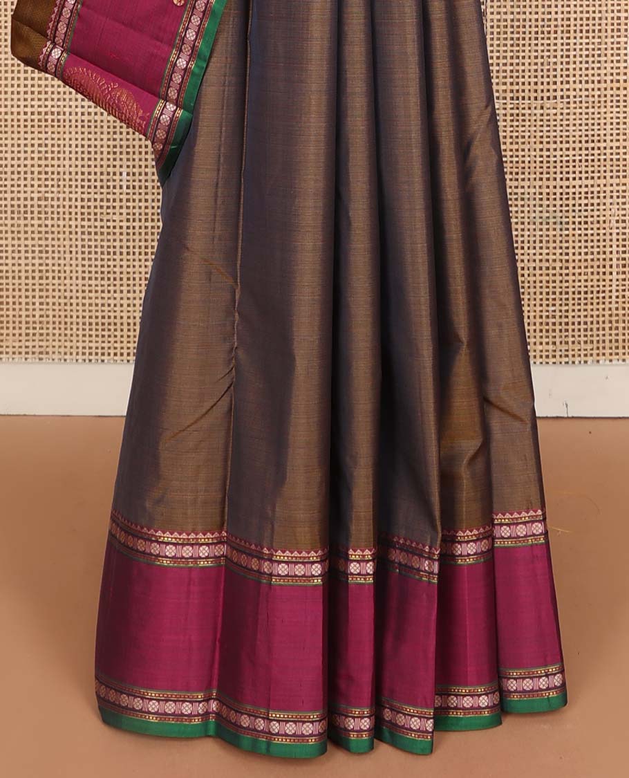 Brown plain Kanchipuram silk saree, contrast border of rekku, muthu, rudraksham, and mayil designs, and zari striped pallu