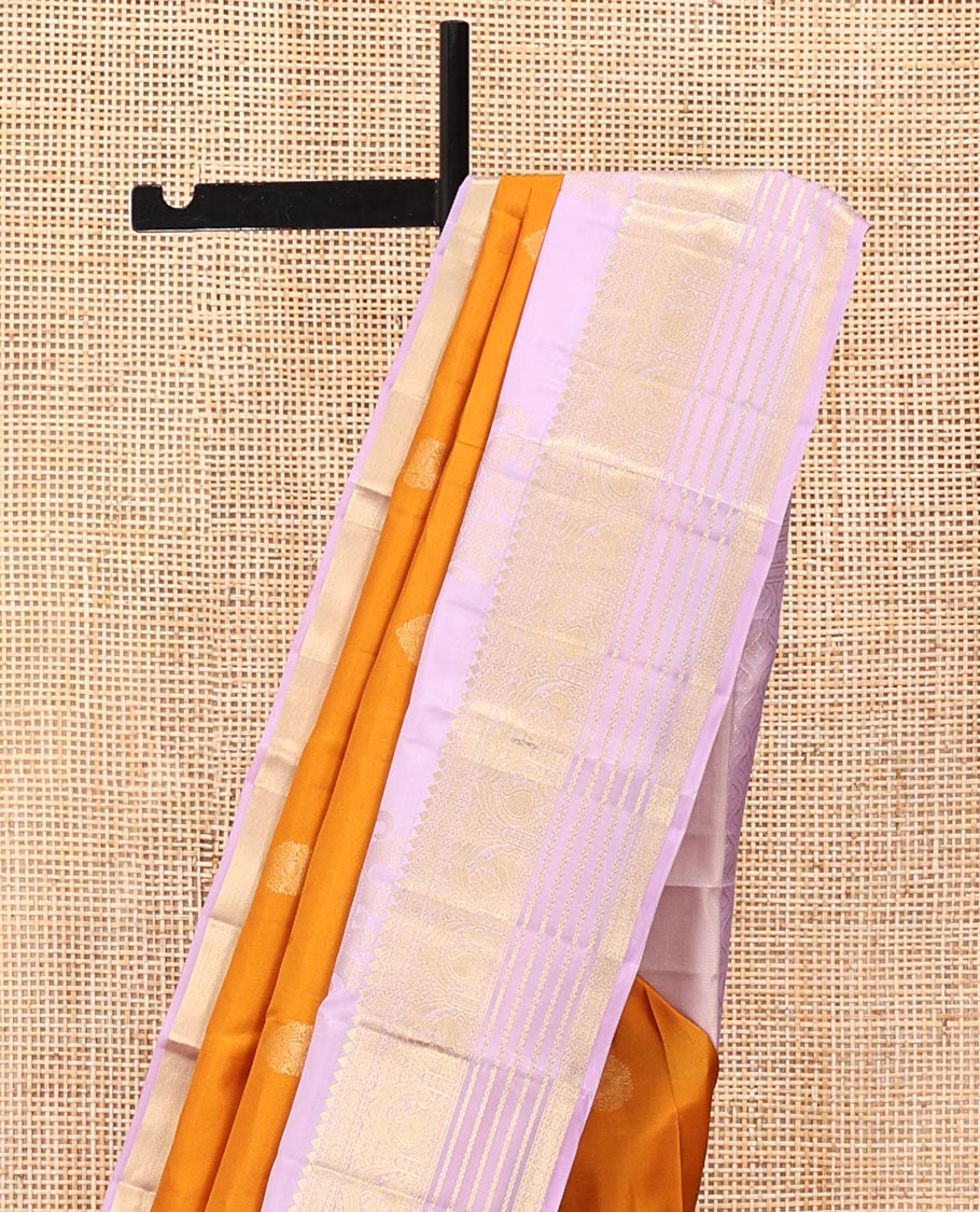 Orange Vasundhara Silk Saree, Decked Up with Zari Buttas All Over Its Body, Complemented by a Contrast Border of Yaanai, Thilakam, Neli, Kamalam, Mayil, and Manga Designs, Grand Jaal Pallu, and Paired with a Contrast Blouse