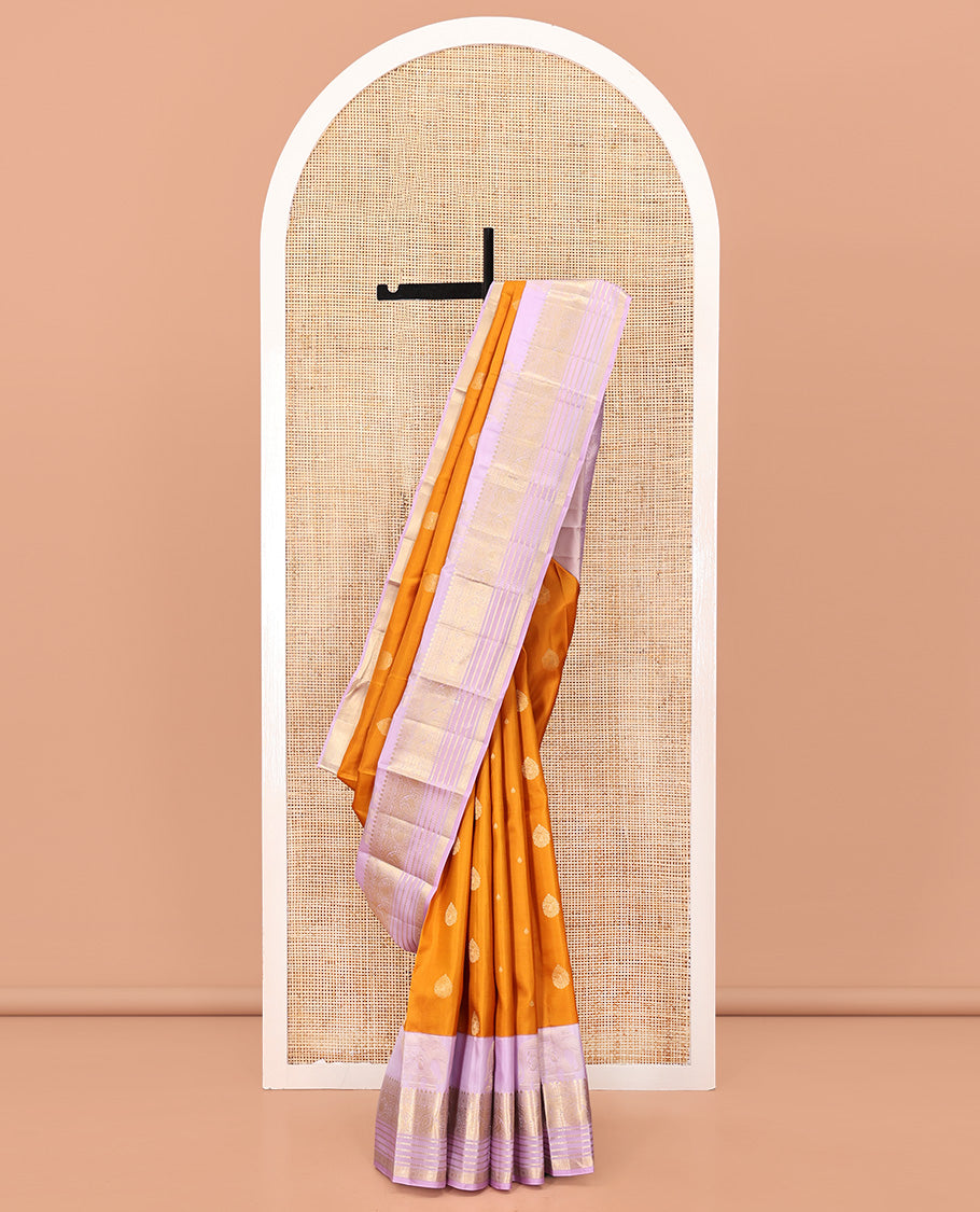 Orange Vasundhara Silk Saree, Decked Up with Zari Buttas All Over Its Body, Complemented by a Contrast Border of Yaanai, Thilakam, Neli, Kamalam, Mayil, and Manga Designs, Grand Jaal Pallu, and Paired with a Contrast Blouse