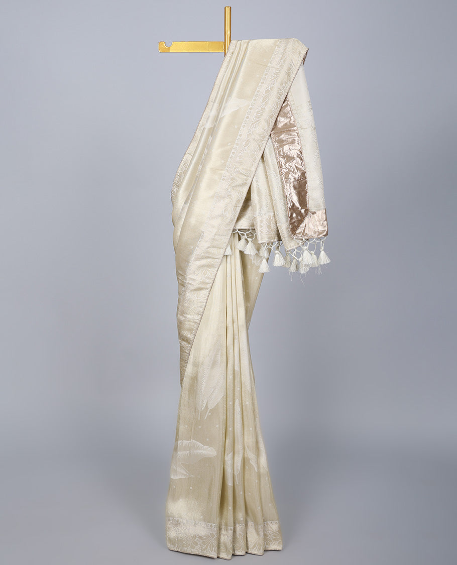 Cream dola silk saree with feather buttas, gleaming border & pallu of intricate designs