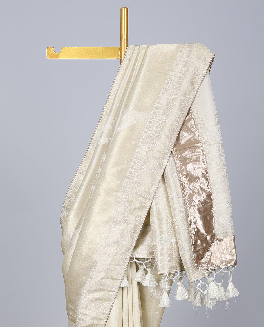 Cream dola silk saree with feather buttas, gleaming border & pallu of intricate designs