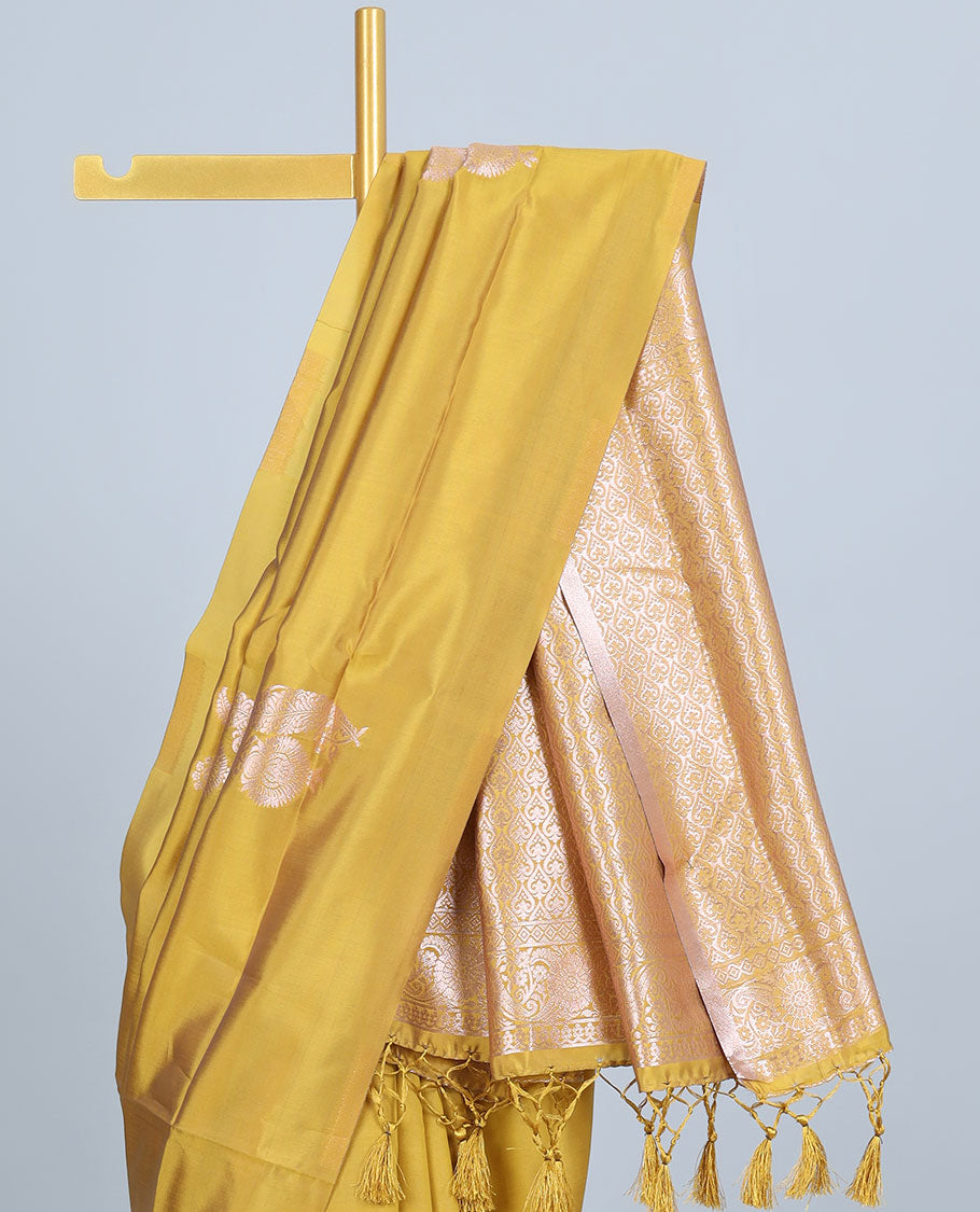 Borderless yellow butter silk saree with zari buttas, self-pallu of ogee patterns