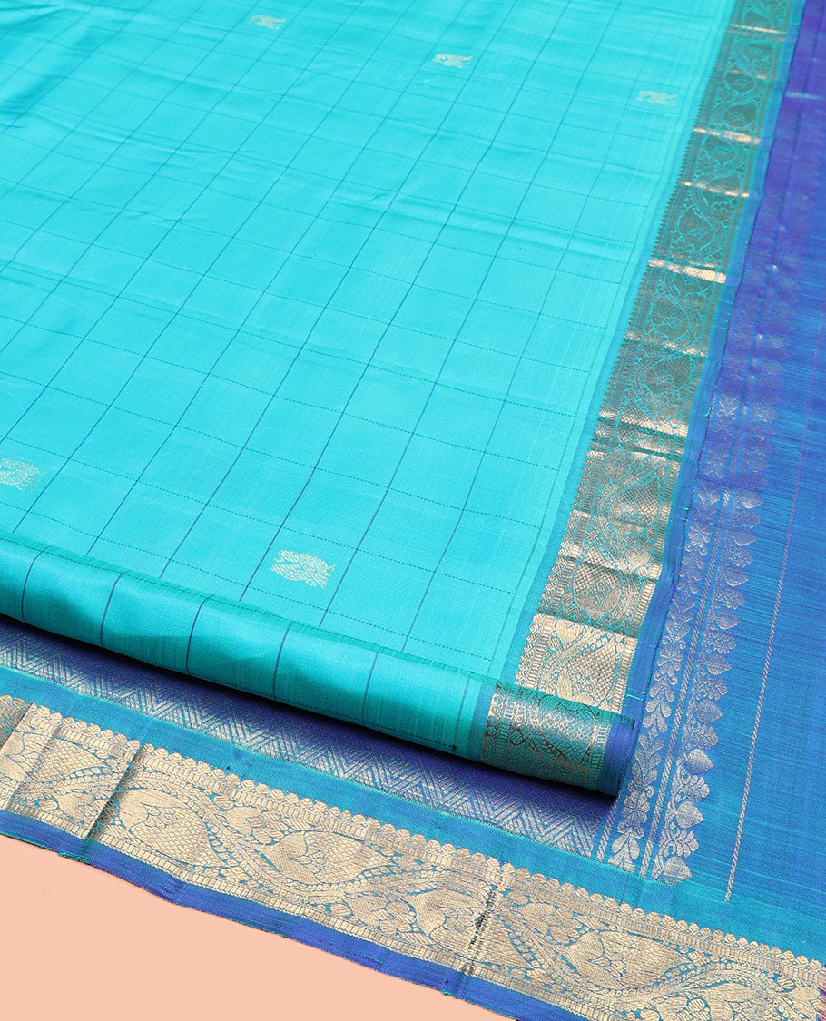 Blue Kanchipuram Silk Saree, Sparsely Sparkled with Mayil Butta Enclosed Checked All Over Its Body, Complemented by a Contrast Traditional Zari Design Border, Pallu of Jaal Designs, and Paired with a Contrast Blouse