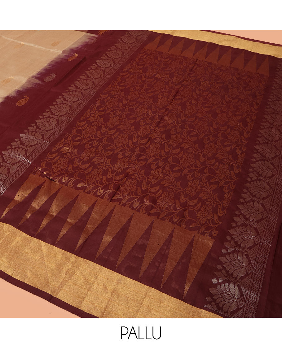 Light Sandal Uppada Silk Saree Highlighted with Paisley Buttas All Over Its Body, Complemented by Contrast Border of Temple and Chariot Designs, Grandly Woven Pallu of Temple Floral Vine Designs, and Paired with a Contrast Blouse