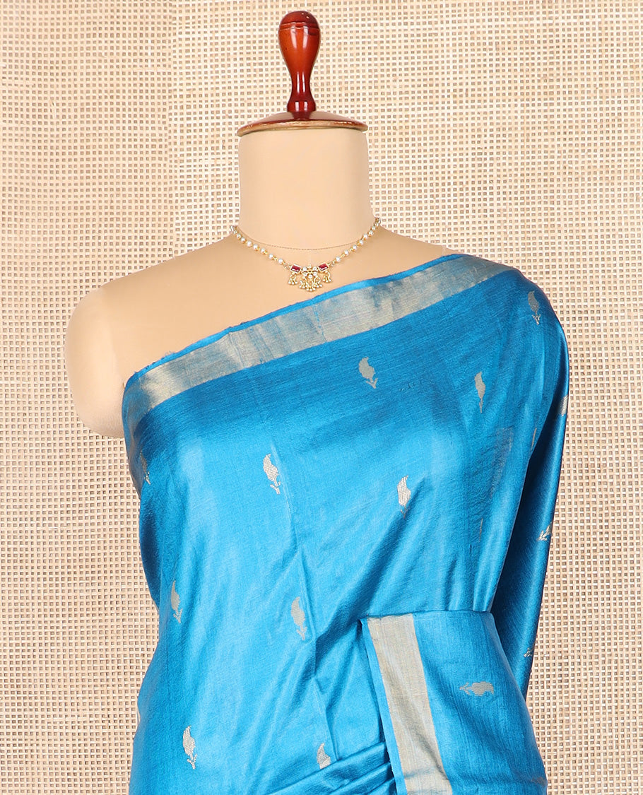 Blue paisley buttas tussar saree, zari border, and pallu of floral designs