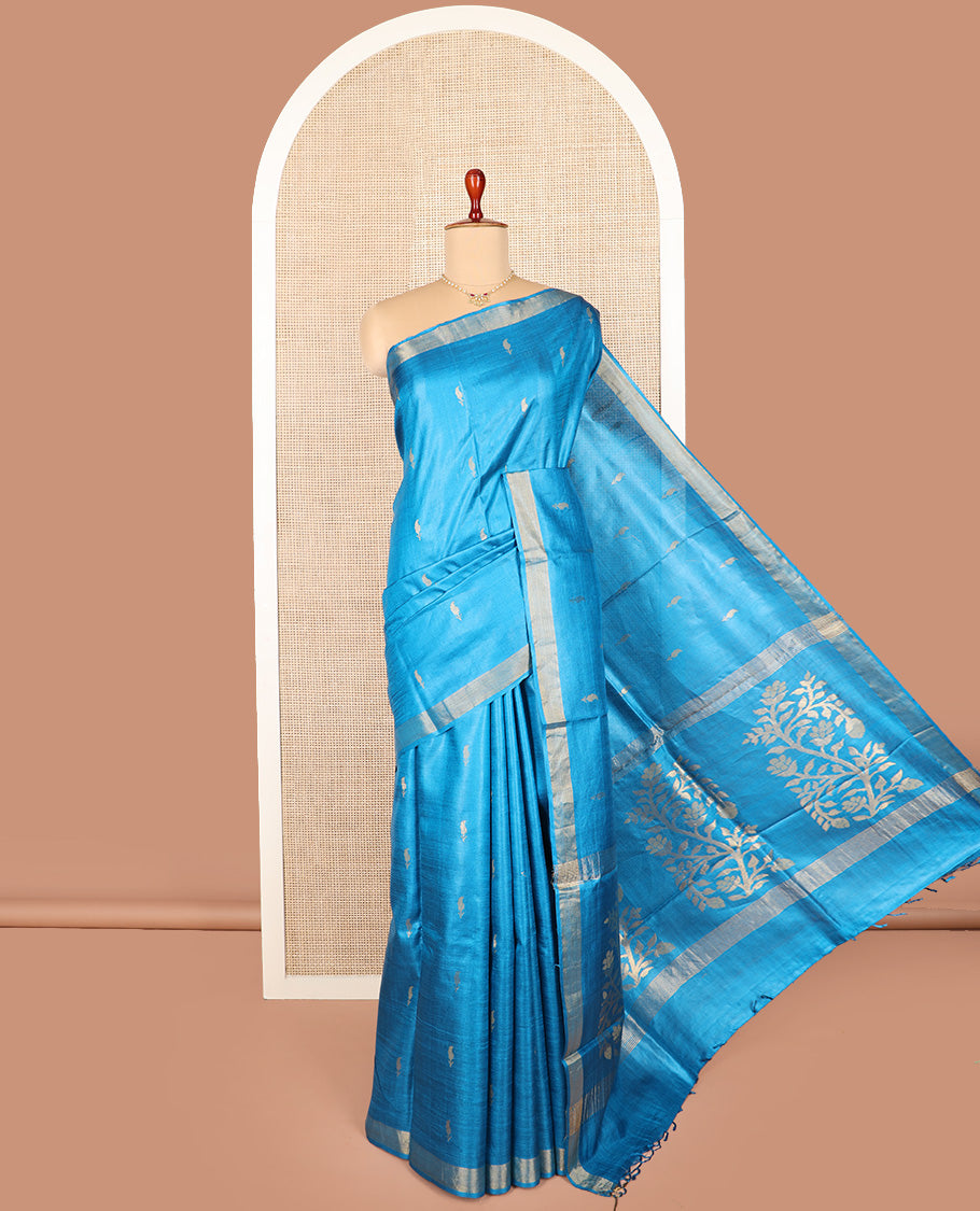 Blue paisley buttas tussar saree, zari border, and pallu of floral designs